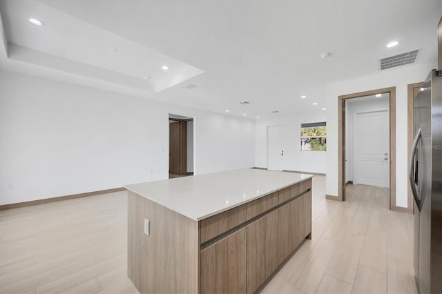2340 Rushmore St, North Port, FL 34288 - kitchen featuring stainless steel refrigerator with ice dispenser, modern cabinets, a large island, recessed lighting, and open floor plan
