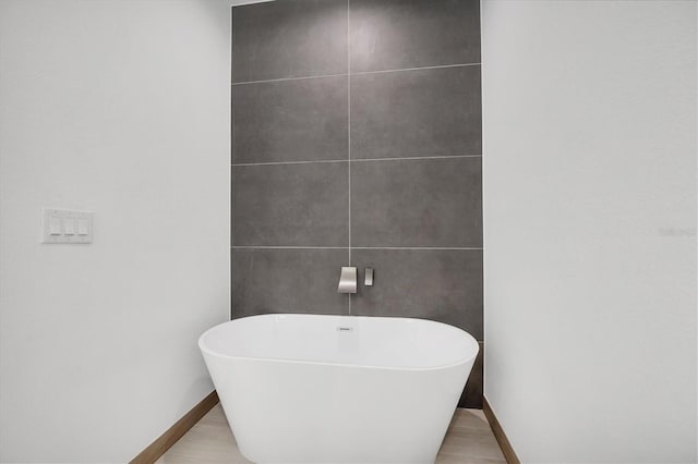 2340 Rushmore St, North Port, FL 34288 - full bathroom featuring a freestanding tub and baseboards