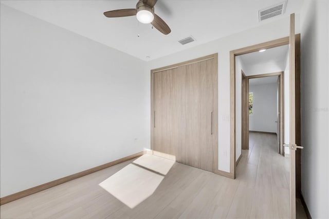 2340 Rushmore St, North Port, FL 34288 - unfurnished bedroom featuring light wood-style flooring, a closet, and a ceiling fan