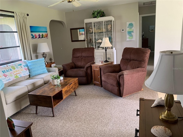 18094 Ackerman Ave, Port Charlotte, FL 33948 - living area featuring light colored carpet, a ceiling fan, and arched walkways