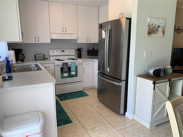 18094 Ackerman Ave, Port Charlotte, FL 33948 - kitchen with freestanding refrigerator, electric stove, under cabinet range hood, light countertops, and white cabinets