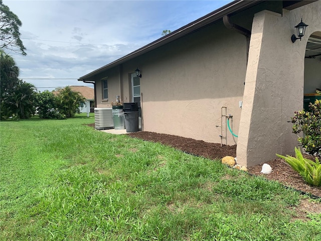 18094 Ackerman Ave, Port Charlotte, FL 33948 - view of home's exterior featuring stucco siding and a lawn