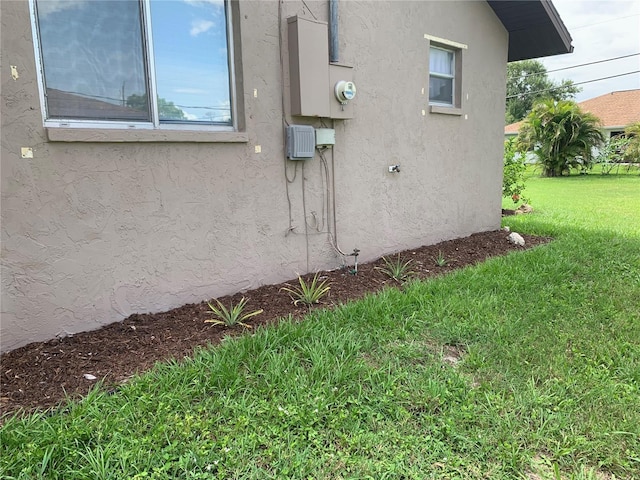 18094 Ackerman Ave, Port Charlotte, FL 33948 - view of home's exterior featuring a yard and stucco siding