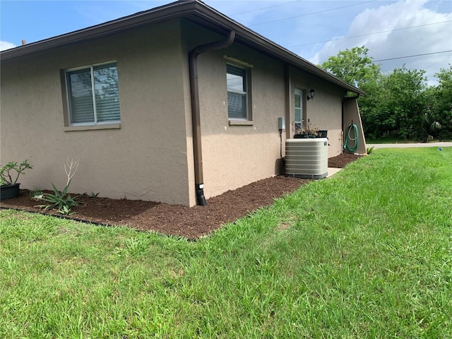 18094 Ackerman Ave, Port Charlotte, FL 33948 - view of property exterior featuring stucco siding and a lawn