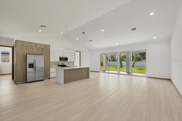 4530 Boston Ter, North Port, FL 34288 - kitchen with appliances with stainless steel finishes, open floor plan, light countertops, white cabinetry, and an island with sink