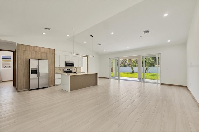 4530 Boston Ter, North Port, FL 34288 - kitchen featuring appliances with stainless steel finishes, open floor plan, light countertops, a kitchen island with sink, and white cabinets