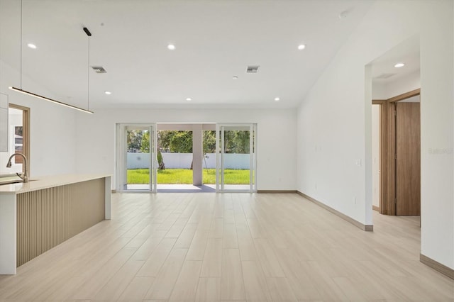4530 Boston Ter, North Port, FL 34288 - unfurnished living room with light wood-style floors and recessed lighting