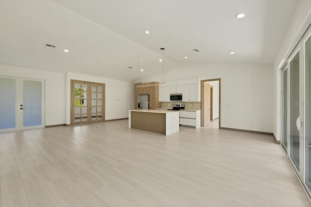 4530 Boston Ter, North Port, FL 34288 - kitchen with french doors, appliances with stainless steel finishes, open floor plan, a center island with sink, and tasteful backsplash
