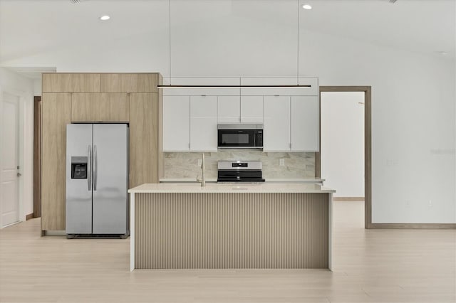 4530 Boston Ter, North Port, FL 34288 - kitchen with stainless steel appliances, light countertops, light wood-style floors, a kitchen island with sink, and backsplash