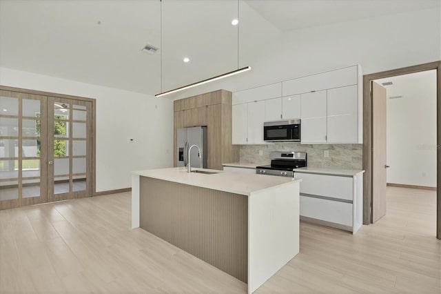 4530 Boston Ter, North Port, FL 34288 - kitchen with stainless steel appliances, tasteful backsplash, french doors, white cabinetry, and modern cabinets