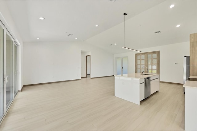 4530 Boston Ter, North Port, FL 34288 - kitchen with stainless steel dishwasher, lofted ceiling, light countertops, a kitchen island with sink, and open floor plan
