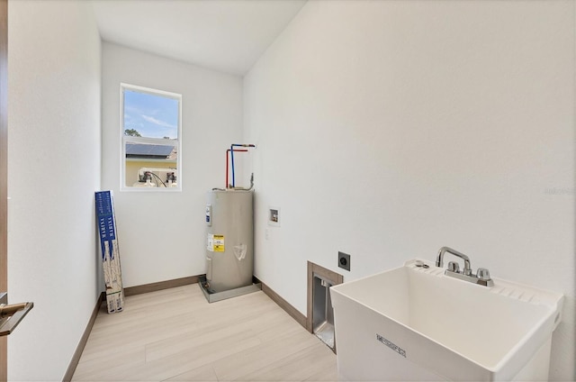 4530 Boston Ter, North Port, FL 34288 - washroom with hookup for an electric dryer, electric water heater, and light wood-style floors