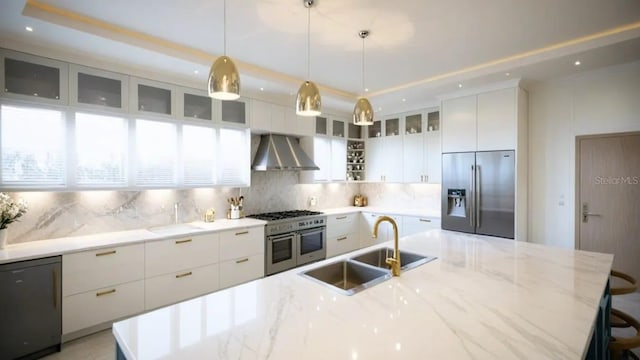 24317 Treasure Island Blvd, Punta Gorda, FL 33955 - kitchen featuring appliances with stainless steel finishes, wall chimney range hood, backsplash, white cabinets, and recessed lighting