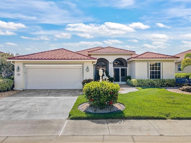 3385 Via Montana Way N, Fort Myers, FL 33917 - mediterranean / spanish-style home with stucco siding, an attached garage, a front yard, concrete driveway, and a tile roof