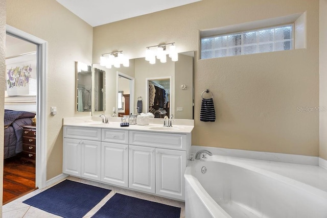 3385 Via Montana Way N, Fort Myers, FL 33917 - ensuite bathroom with double vanity, a garden tub, and tile patterned floors
