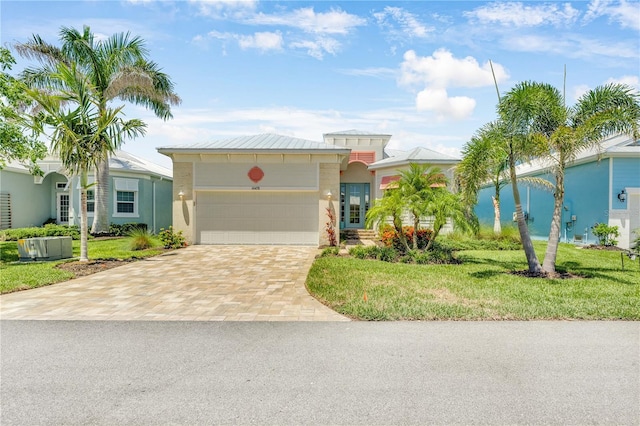 10478 Coquina Ct, Placida, FL 33946 - view of front facade with driveway, stucco siding, a front lawn, and an attached garage