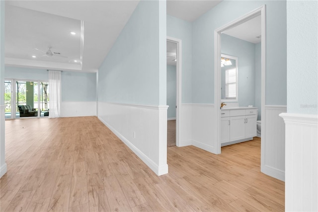 10478 Coquina Ct, Placida, FL 33946 - corridor featuring a wainscoted wall and light wood finished floors