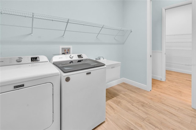 10478 Coquina Ct, Placida, FL 33946 - washroom featuring separate washer and dryer and light wood finished floors