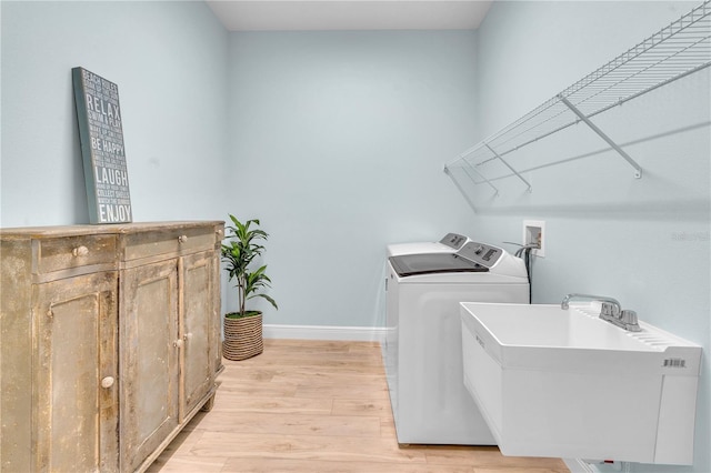 10478 Coquina Ct, Placida, FL 33946 - laundry area featuring independent washer and dryer and light wood finished floors