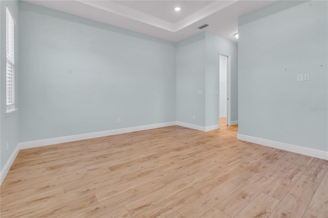 10478 Coquina Ct, Placida, FL 33946 - spare room featuring light wood-type flooring, crown molding, recessed lighting, and a tray ceiling