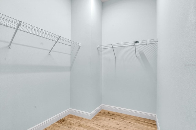 10478 Coquina Ct, Placida, FL 33946 - walk in closet with light wood-type flooring