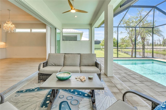 10478 Coquina Ct, Placida, FL 33946 - outdoor pool with ceiling fan, an outdoor living space, a water view, a patio, and glass enclosure