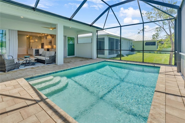 10478 Coquina Ct, Placida, FL 33946 - outdoor pool with a patio, glass enclosure, outdoor lounge area, and ceiling fan