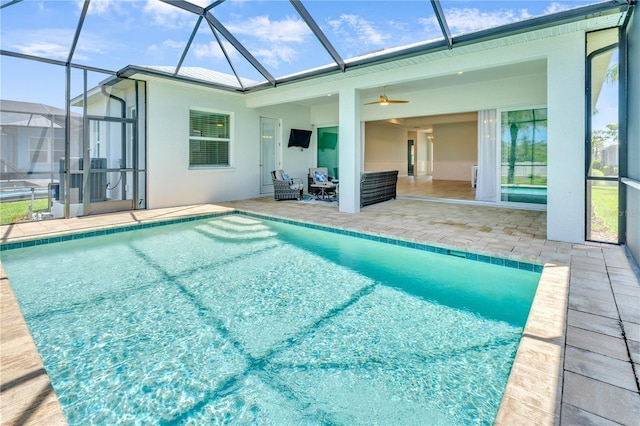 10478 Coquina Ct, Placida, FL 33946 - swimming pool with a patio area, glass enclosure, outdoor lounge area, and a ceiling fan
