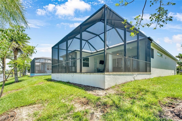10478 Coquina Ct, Placida, FL 33946 - back of house featuring a lawn and a lanai