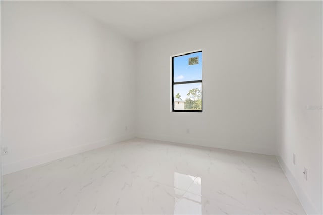 2911 37th St W, Lehigh Acres, FL 33971 - empty room featuring light marble finish flooring and baseboards