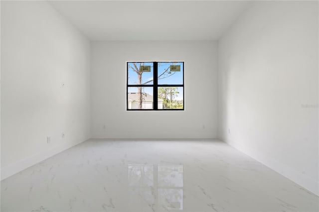 2911 37th St W, Lehigh Acres, FL 33971 - spare room featuring baseboards and marble look tile flooring