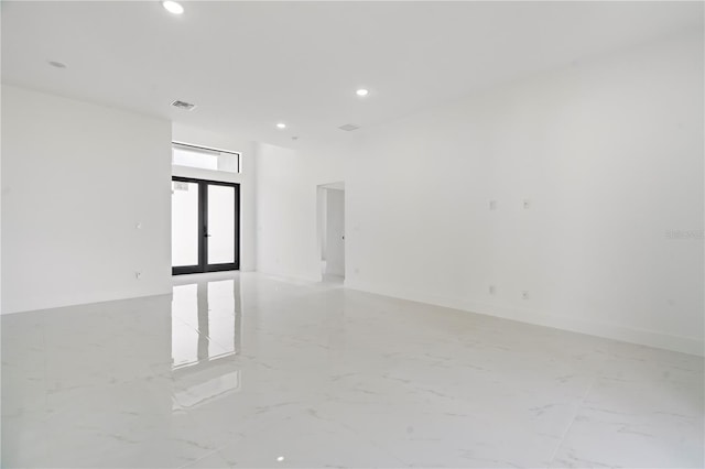 2911 37th St W, Lehigh Acres, FL 33971 - empty room with recessed lighting, french doors, and light marble finish flooring