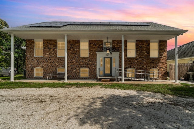 6605 NE Masters Ave, Arcadia, FL 34266 - bi-level home with solar panels, brick siding, and covered porch