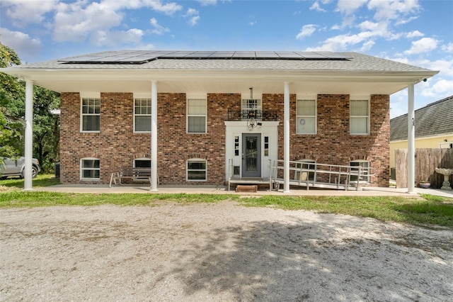 6605 NE Masters Ave, Arcadia, FL 34266 - view of front facade with brick siding and solar panels