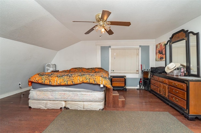 6605 NE Masters Ave, Arcadia, FL 34266 - bedroom featuring dark wood-style flooring, vaulted ceiling, a ceiling fan, and a textured ceiling