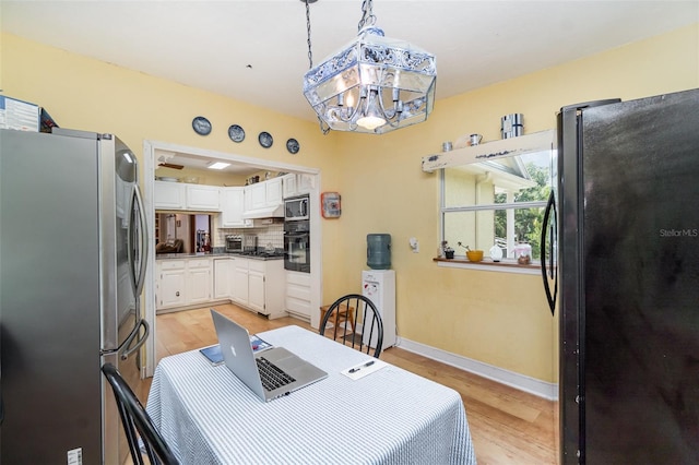 6605 NE Masters Ave, Arcadia, FL 34266 - dining room with light wood-style flooring, a chandelier, and a desk