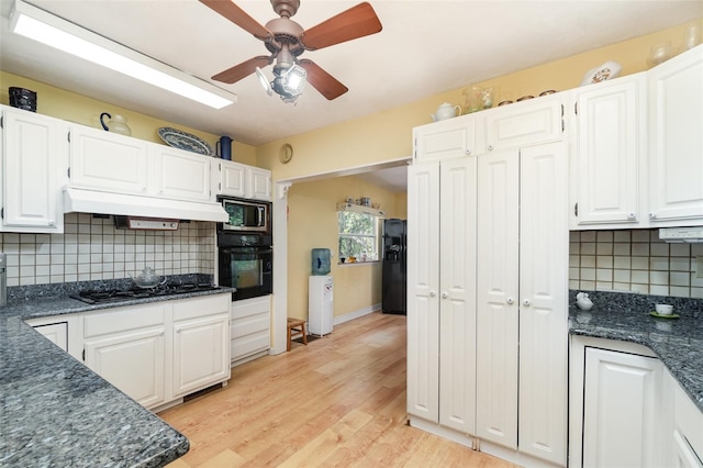 6605 NE Masters Ave, Arcadia, FL 34266 - kitchen with black appliances, premium range hood, a ceiling fan, white cabinets, and backsplash