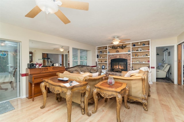 6605 NE Masters Ave, Arcadia, FL 34266 - living room with ceiling fan, light wood-type flooring, and a brick fireplace
