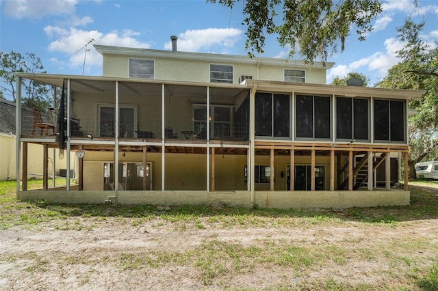 6605 NE Masters Ave, Arcadia, FL 34266 - rear view of property with a sunroom, stucco siding, and stairway