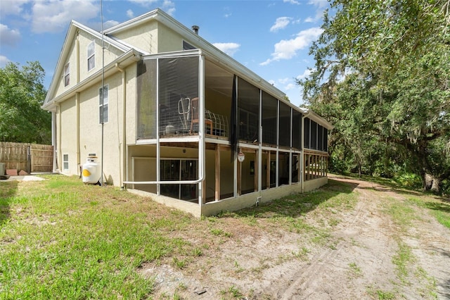 6605 NE Masters Ave, Arcadia, FL 34266 - view of home's exterior featuring a sunroom and stucco siding