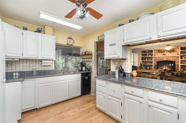 6605 NE Masters Ave, Arcadia, FL 34266 - kitchen featuring black dishwasher, light wood-type flooring, ceiling fan, and white cabinets