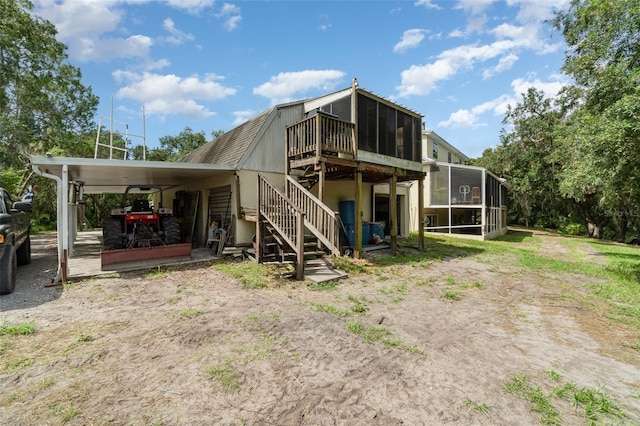 6605 NE Masters Ave, Arcadia, FL 34266 - back of house featuring a sunroom, stairs, and a deck