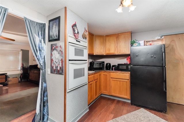 6605 NE Masters Ave, Arcadia, FL 34266 - kitchen featuring black appliances and dark wood-style floors