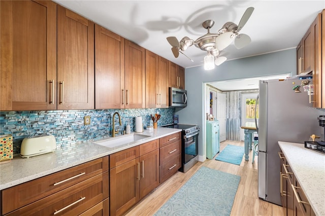 1027 Coral Ridge Dr, Punta Gorda, FL 33950 - kitchen featuring appliances with stainless steel finishes, ceiling fan, decorative backsplash, and brown cabinets