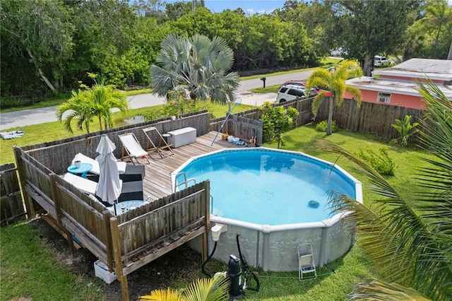 1027 Coral Ridge Dr, Punta Gorda, FL 33950 - view of swimming pool featuring a deck, a fenced backyard, and view of wooded area