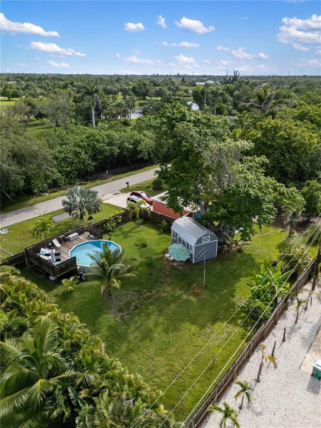 1027 Coral Ridge Dr, Punta Gorda, FL 33950 - drone / aerial view of a pool area and a heavily wooded area