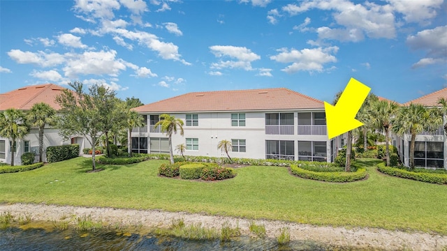 17454 Old Harmony Dr Unit 101, Fort Myers, FL 33908 - back of house with stucco siding, a lawn, and a tile roof