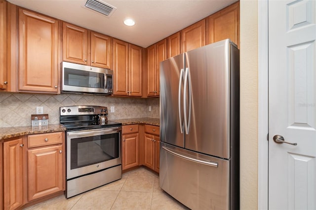 17454 Old Harmony Dr Unit 101, Fort Myers, FL 33908 - kitchen with stainless steel appliances, light tile patterned flooring, backsplash, light stone countertops, and recessed lighting