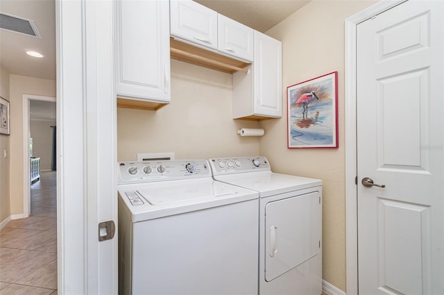 17454 Old Harmony Dr Unit 101, Fort Myers, FL 33908 - laundry area featuring washer and clothes dryer, cabinet space, and light tile patterned floors