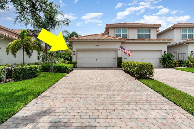 17454 Old Harmony Dr Unit 101, Fort Myers, FL 33908 - mediterranean / spanish home featuring stucco siding, decorative driveway, and a tile roof